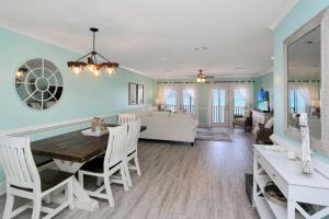 a dining room and living room with a table and chairs at Edgewater Retreat by Pristine Properties Vacation Rentals in Cape San Blas