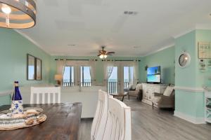 a dining room and living room with a table and chairs at Edgewater Retreat by Pristine Properties Vacation Rentals in Cape San Blas