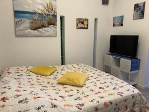 a bedroom with a bed with two yellow pillows on it at Villa Casa rosa Maria in Platja d'Aro