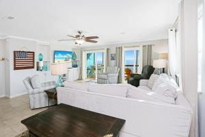 a living room with a white couch and chairs at Pelican Crossing by Pristine Properties Vacation Rentals in Cape San Blas