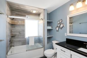 a bathroom with a tub and a toilet and a sink at Pelican Crossing by Pristine Properties Vacation Rentals in Cape San Blas +38 photos