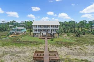 a large building with picnic tables in front of it at Pelican Landing 3 by Pristine Properties Vacation Rentals in Indian Pass