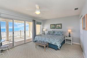 a bedroom with a bed and a balcony with the ocean at Pelican Landing 2 by Pristine Properties Vacation Rentals in Indian Pass