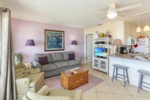a living room with a couch and a kitchen at Pelican Landing 2 by Pristine Properties Vacation Rentals in Indian Pass +42 photos