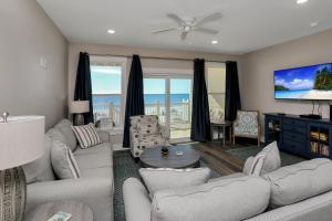 a living room with a couch and a tv at Pelican's Perch by Pristine Properties Vacation Rentals in Saint Joe Beach