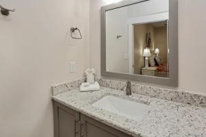 a bathroom with a sink and a mirror at Pelican's Perch by Pristine Properties Vacation Rentals in Saint Joe Beach +43 photos