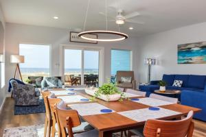 a dining room with a table and a blue couch at Sea La Vie by Pristine Properties Vacation Rentals in Mexico Beach