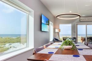 a dining room with a table and a view of the ocean at Sea La Vie by Pristine Properties Vacation Rentals in Mexico Beach