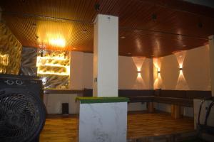a room with a bench and lights on the wall at Mehi villa in Ghaziabad