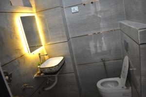 a small bathroom with a toilet and a sink at Mehi villa in Ghaziabad