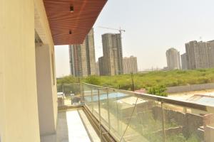 a balcony with a view of a city with tall buildings at Mehi villa in Ghaziabad +14 photos