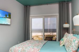 a bedroom with a bed and a view of the ocean at Sea La Vie by Pristine Properties Vacation Rentals in Mexico Beach