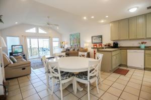 a kitchen and living room with a white table and chairs at 2-The-Beach by Pristine Properties Vacation Rentals in Indian Pass