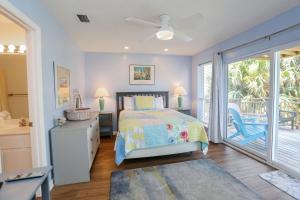 a bedroom with a bed and a sliding glass door at 2-The-Beach by Pristine Properties Vacation Rentals in Indian Pass +40 photos