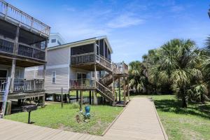 a house with balconies and a walkway in front of it at 2-The-Beach by Pristine Properties Vacation Rentals in Indian Pass