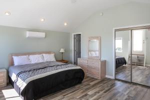 a bedroom with a large bed and a mirror at A New Beginning by Pristine Properties Vacation Rentals in Indian Pass +25 photos