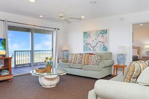 a living room with a couch and a table at Flamingo Dunes by Pristine Properties Vacation Rentals in Saint Joe Beach