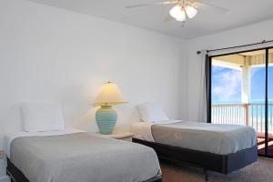 two beds in a room with a view of the ocean at Flamingo Dunes by Pristine Properties Vacation Rentals in Saint Joe Beach
