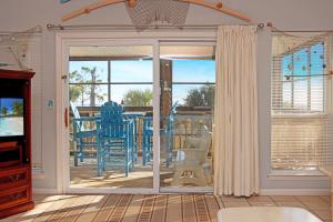 a living room with a sliding glass door to a patio at Gulfside GEM by Pristine Properties Vacation Rentals in Indian Pass