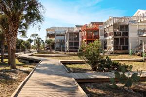 a walkway in front of some apartment buildings at Gulfside GEM by Pristine Properties Vacation Rentals in Indian Pass