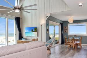 a living room with a couch and a table with chairs at Indian Summer by Pristine Properties Vacation Rentals in Indian Pass