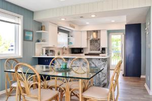 a kitchen with a glass table and chairs at Indian Summer by Pristine Properties Vacation Rentals in Indian Pass