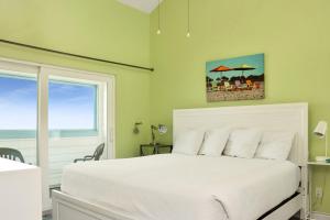 a bedroom with a white bed and a window at Indian Summer by Pristine Properties Vacation Rentals in Indian Pass +57 photos