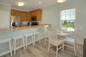 a kitchen with a table and chairs and a counter at Dunes Club 1A by Pristine Properties Vacation Rentals in Cape San Blas