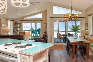 a kitchen and living room with a stove and a table at WindScape by Pristine Properties Vacation Rentals in Indian Pass