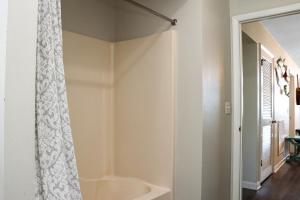 a bathroom with a shower curtain and a tub at WindScape by Pristine Properties Vacation Rentals in Indian Pass +46 photos