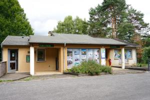 a small building with a lot of windows at Camping Les Aubazines in Bort-les-Orgues +18 photos