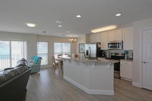 a kitchen and living room with a couch and a counter at Surfside 16 by Pristine Properties Vacation Rentals in Mexico Beach