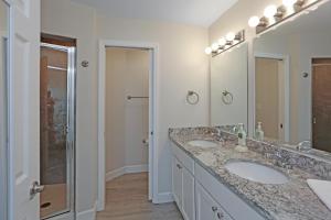 a bathroom with two sinks and a shower at Surfside 16 by Pristine Properties Vacation Rentals in Mexico Beach +45 photos