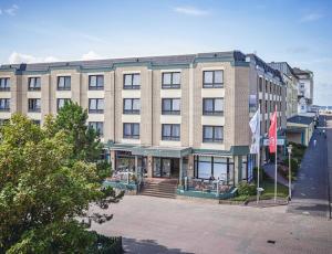 a large building with a store in front of it at Aparthotel Kachelot in Borkum