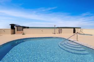 a swimming pool with blue water in a resort at The Vue 2C by Pristine Properties Vacation Rentals in Mexico Beach