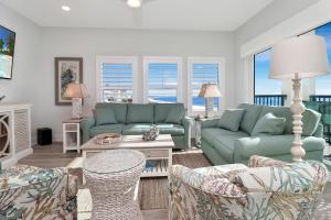 a living room with blue couches and chairs at The Vue 2C by Pristine Properties Vacation Rentals in Mexico Beach