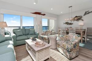 a living room with a couch and chairs and a table at The Vue 2C by Pristine Properties Vacation Rentals in Mexico Beach