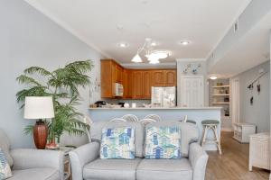a living room with a couch and a kitchen at Dunes Club 1D by Pristine Properties Vacation Rentals in Cape San Blas