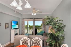 a living room with a couch and a tv at Dunes Club 1D by Pristine Properties Vacation Rentals in Cape San Blas
