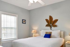 a bedroom with a white bed with a blue pillow at Dunes Club 1D by Pristine Properties Vacation Rentals in Cape San Blas +33 photos