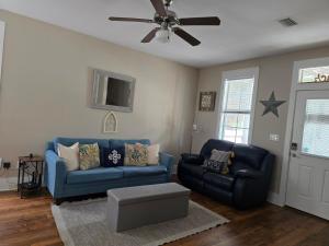 a living room with a blue couch and a ceiling fan at Barefoot Cottage B37 by Pristine Properties in Highland View