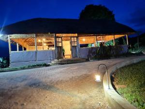a small building with a roof at night at Bwindi Coffee Lodge in Kachulagenyi