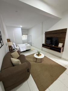 a large living room with a couch and a tv at Habitación centro in Ciudad del Este