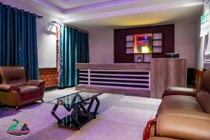 a waiting room with two chairs and a table at Legacy Chillout Kasese in Kasese