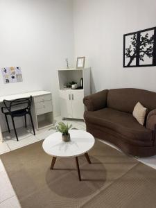 a living room with a couch and a table at Habitación centro in Ciudad del Este