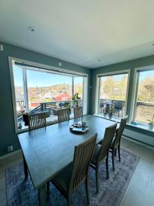a dining room with a large wooden table and chairs at Modern 3BR Apartment Near Oslo Center Free Parking in Lorenskog