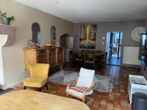 a living room with chairs and a dining room at La Lone 1870 in La Roche-de-Glun