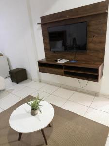 a living room with a tv and a table at Habitación centro in Ciudad del Este