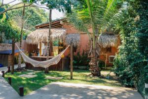a hammock in front of a house at Villa Arumã Pousada in Alter do Chao
