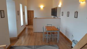a kitchen and dining room with a table and chairs at The Uyeasound Old Pier Cottage in Belmont +12 photos